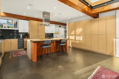 a kitchen with stainless steel appliances a sink a counter top space and cabinets