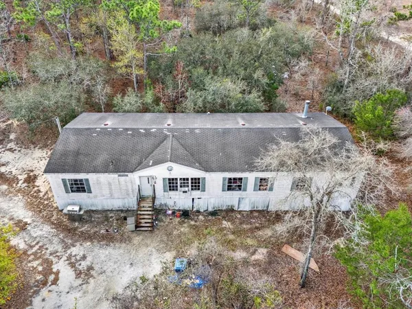 an aerial view of a house with a yard
