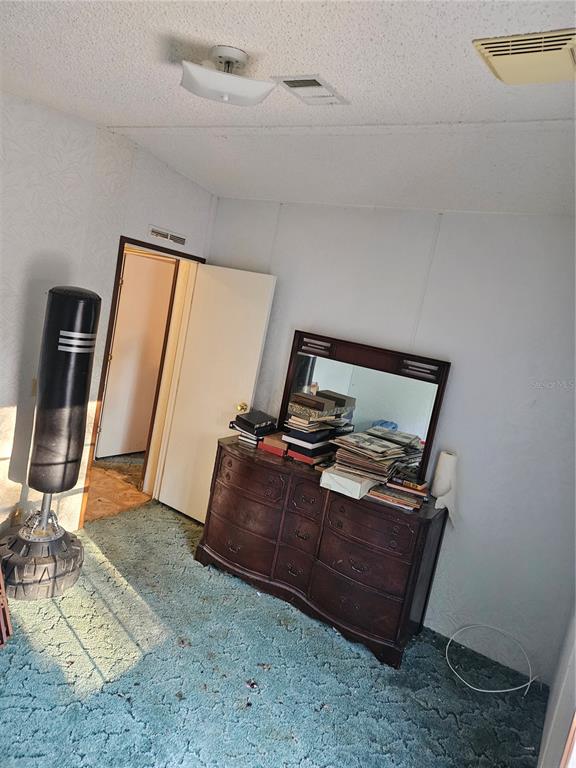 14018 Hexam Road Brooksville, FL 34613 - Photo 11 of 17 a bed sitting in a room next to a window