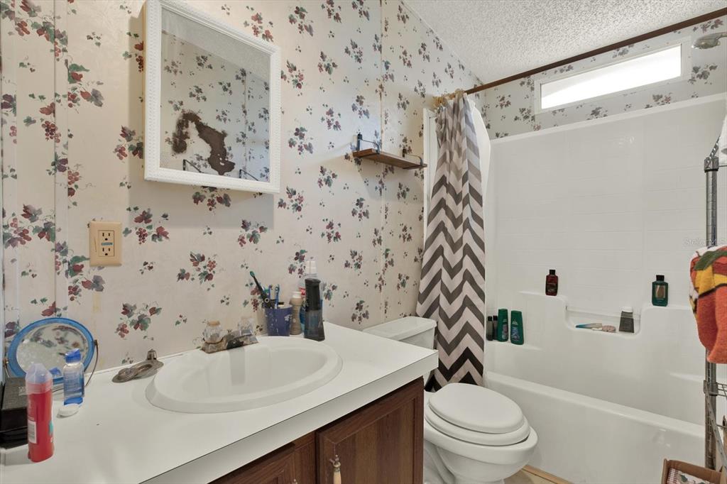 14018 Hexam Road Brooksville, FL 34613 - Photo 12 of 17 a bathroom with a sink toilet and shower