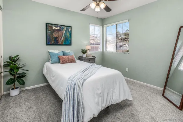 a bedroom with a bed and a potted plant