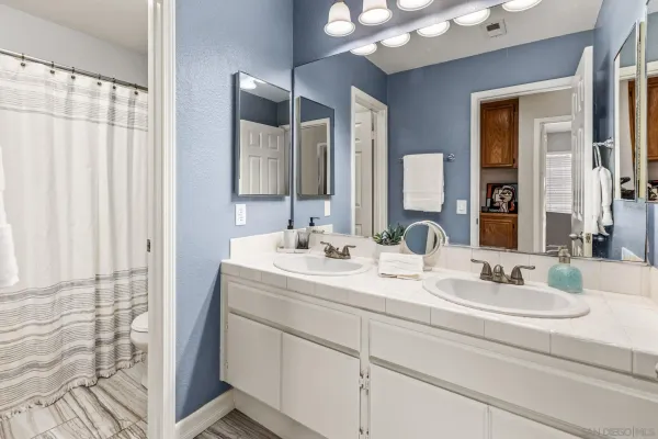 a bathroom with a double vanity sink and a mirror