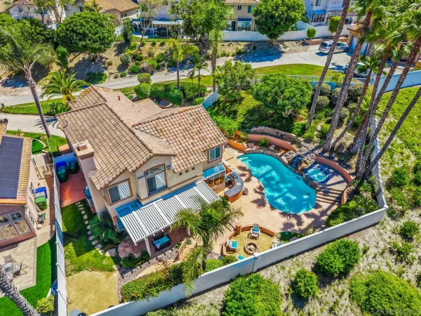 an aerial view of a house with garden space and street view