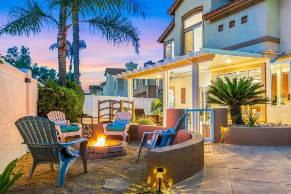 a view of a patio with couches and a table and chairs under an umbrella