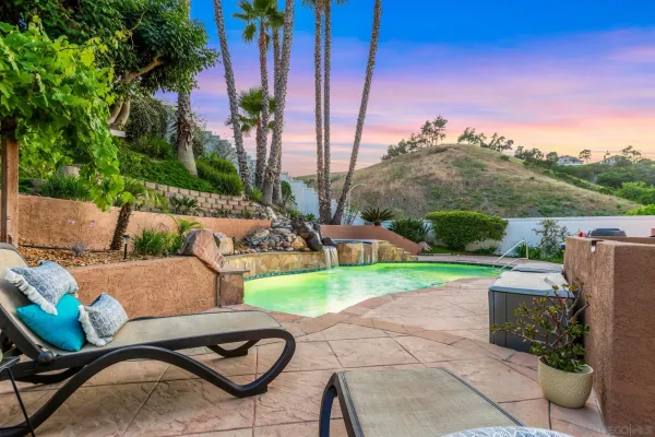 a view of backyard with outdoor seating and green space
