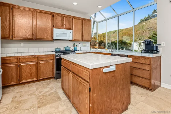 a kitchen with stainless steel appliances granite countertop a sink and cabinets