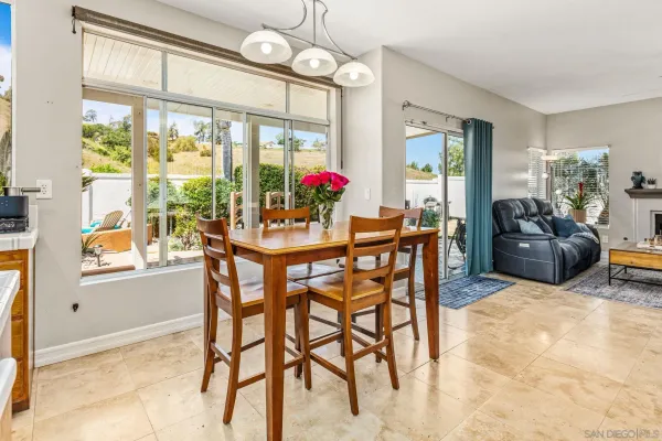 a dining room with furniture a chandelier and a rug
