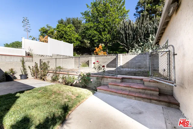 a view of a backyard with sitting area