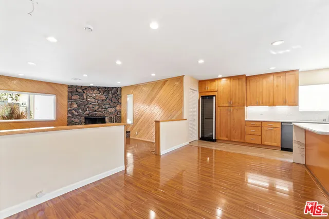 a view of a big room with wooden floor and windows
