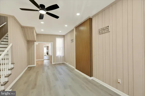 a view of a hallway with a ceiling fan