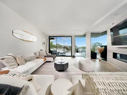 a living room with furniture a fireplace and a large window