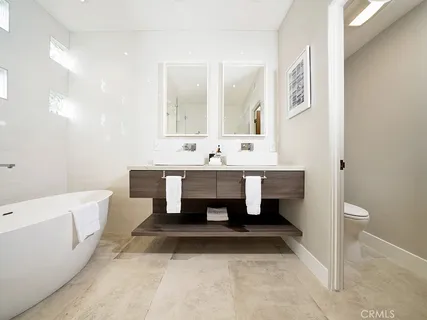 a bathroom with a tub sink and mirror