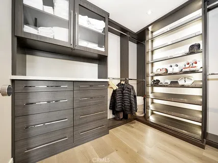 a view of walk in closet with clothes and shoes