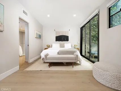 a bedroom with a large bed and a large window