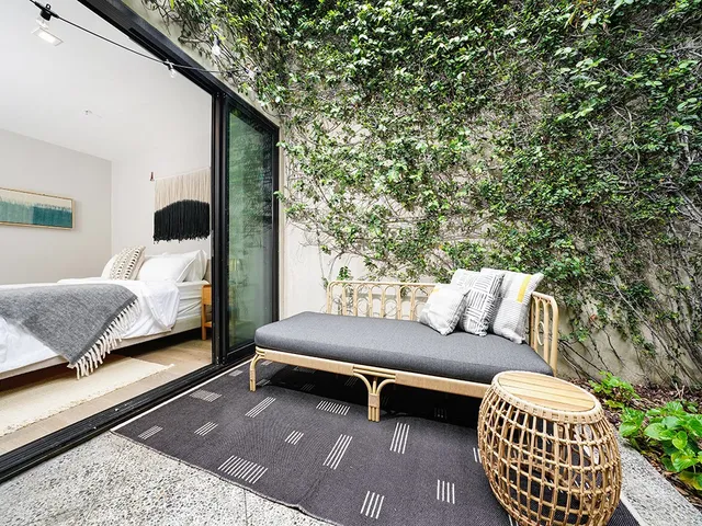 a outdoor living space with furniture and a rug