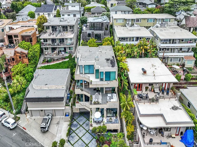 an aerial view of multiple houses with yard
