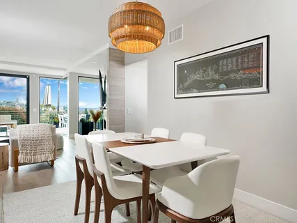 a view of a dining room with furniture wooden floor and a chandelier