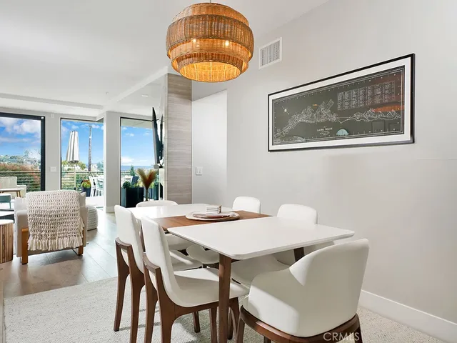 a view of a dining room with furniture wooden floor and a chandelier
