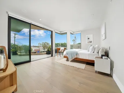 a bedroom with a bed and large window