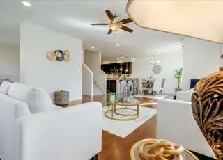 a kitchen with stainless steel appliances kitchen island granite countertop a table and chairs in it