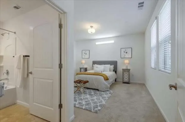 a bedroom with a bed and a window