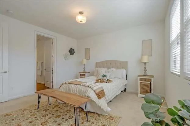 a bedroom with a bed and a window