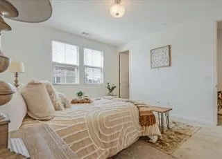 a bedroom with a bed and window