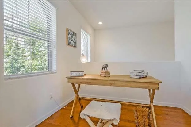 a view of a workspace with furniture and window