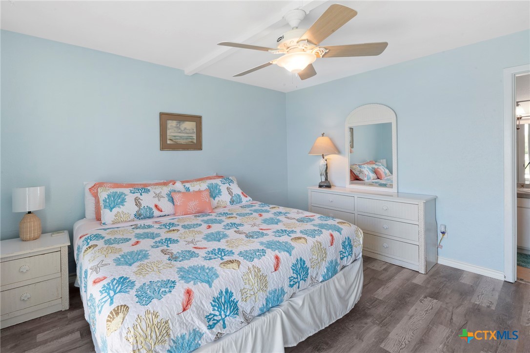 2003 North Fulton Beach Road, Unit 77 Rockport, TX 78382 - Photo 17 of 33 a bedroom with a bed and a chandelier