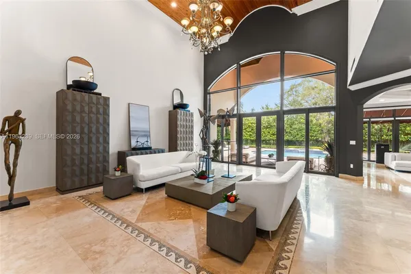 a living room with furniture a flat screen tv and a large window