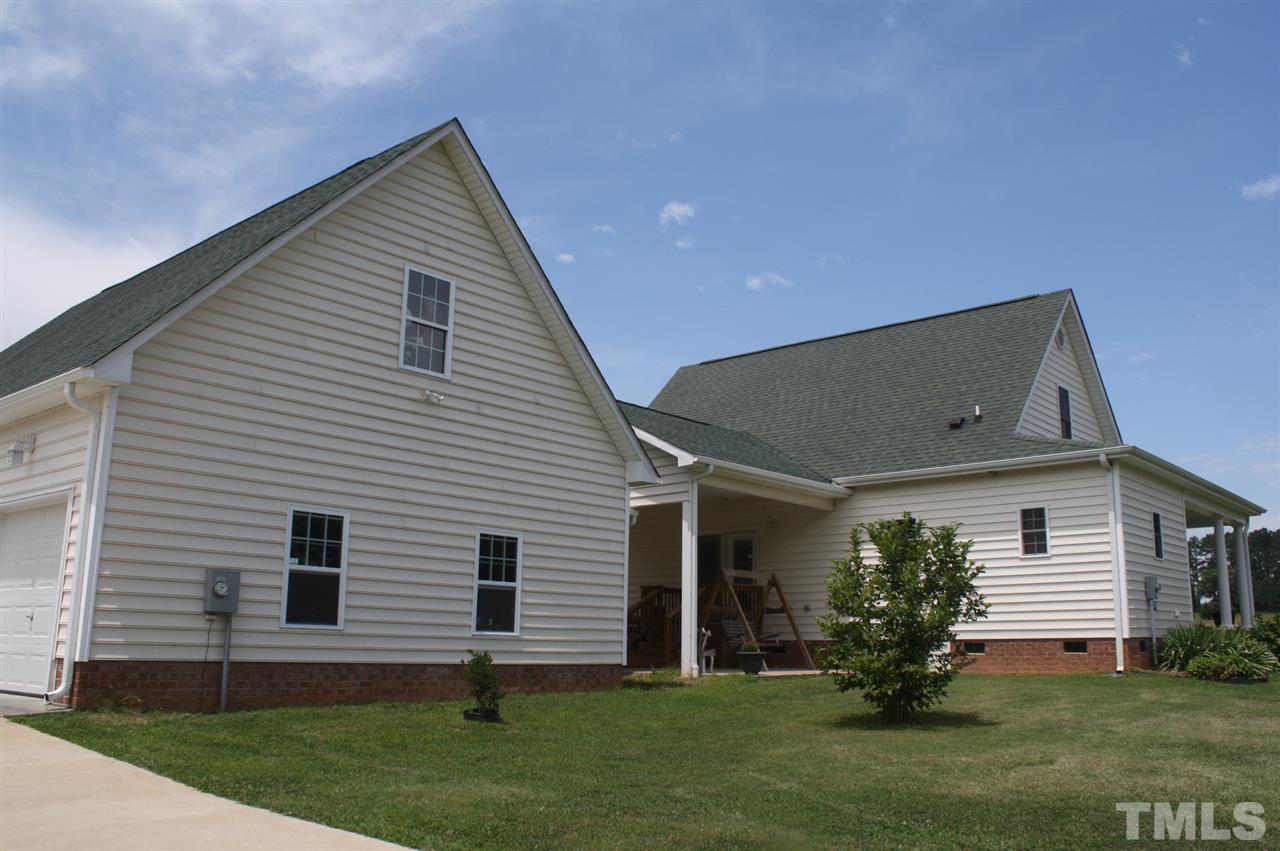 385 Huford Harris Road Spring Hope, NC 27882 - Photo 2 of 25 Home boasts an over-sized 3-car garage with a lg storage above that could be finished for additional living space. A covered breezeway adjoining the garage to the home provides protection from the weather. Home features vinyl siding for easy maintenance.