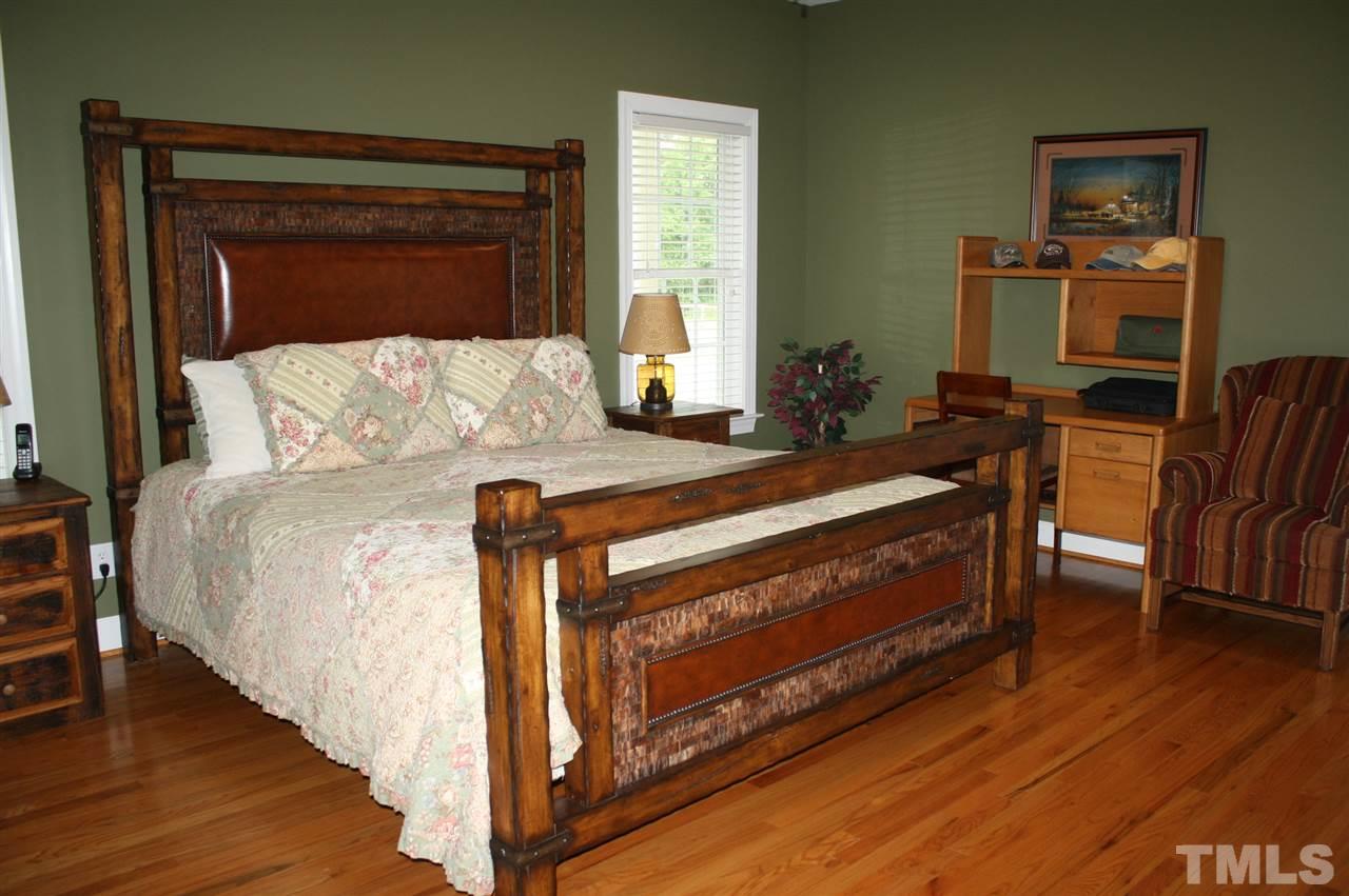 385 Huford Harris Road Spring Hope, NC 27882 - Photo 12 of 25 You will rest well in this spacious master bedroom which boasts gleaming hardwood flooring and a ceiling fan with light kit for your convenience and comfort.