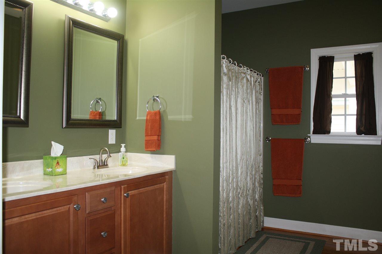 385 Huford Harris Road Spring Hope, NC 27882 - Photo 13 of 25 This lovely master bath boasts dual sinks graced with framed mirrors and glamour lighting. Room features a tub/shower combination, large walk-in closet and a water closet.