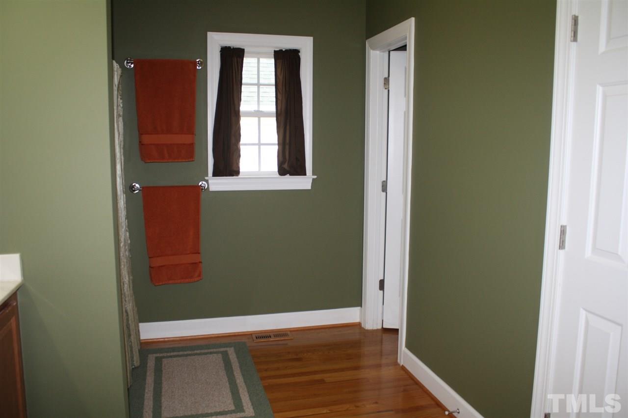 385 Huford Harris Road Spring Hope, NC 27882 - Photo 14 of 25 A double-door entry leads to this spacious master bath which boasts beautiful hardwood flooring. Room features a large vanity with dual sinks, a walk-in closet and a water closet.