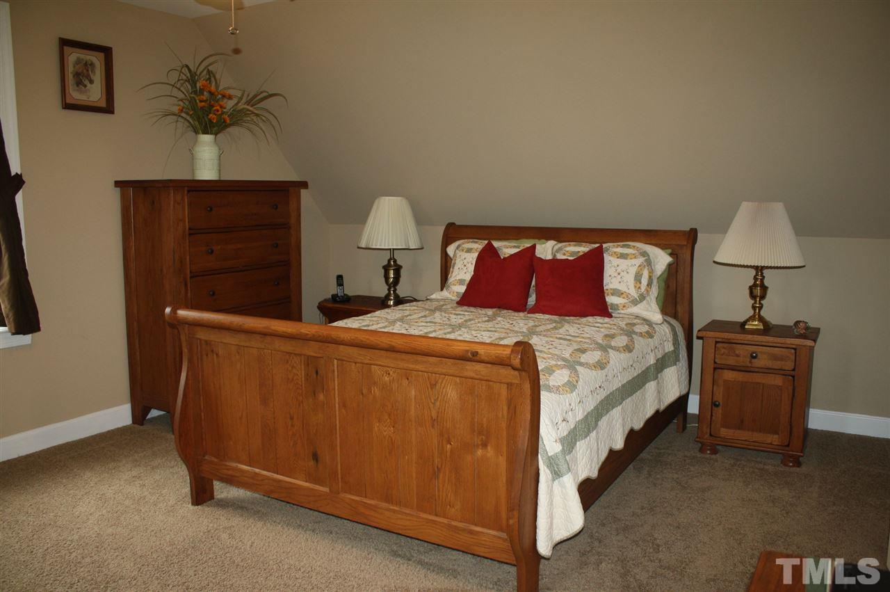 385 Huford Harris Road Spring Hope, NC 27882 - Photo 15 of 25 This large upstairs bedroom is tastefully decorated and features a spacious walk-in closet with alcove storage, and additional alcove storage in the room.