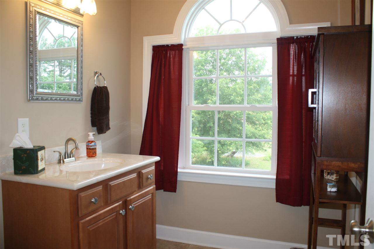 385 Huford Harris Road Spring Hope, NC 27882 - Photo 16 of 25 This lovely and spacious bath features a walk-in shower and a beautiful palladium window to let in plenty of natural lighting.
