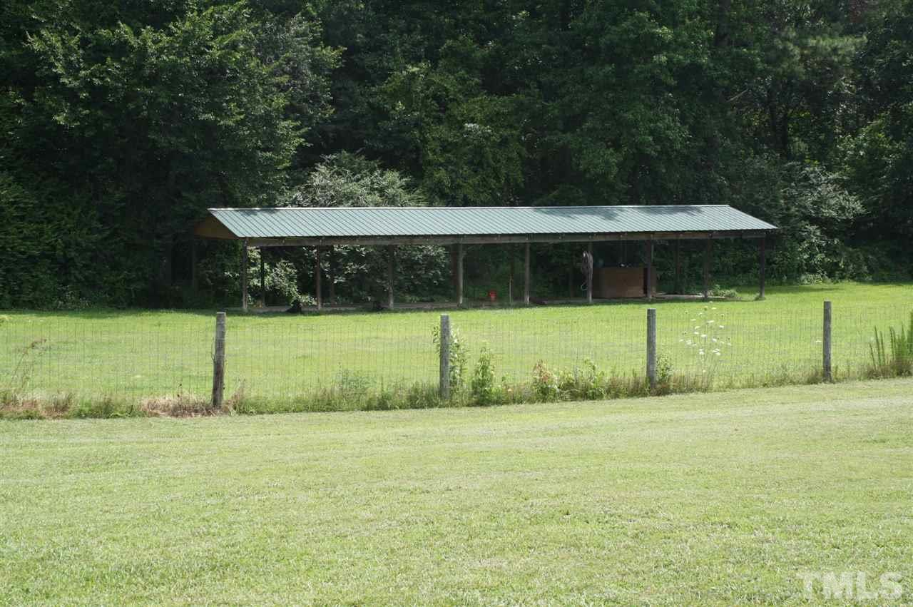 385 Huford Harris Road Spring Hope, NC 27882 - Photo 22 of 25 This huge dog kennel is fenced in for your convenience. Water and electricity have been run to the kennel.