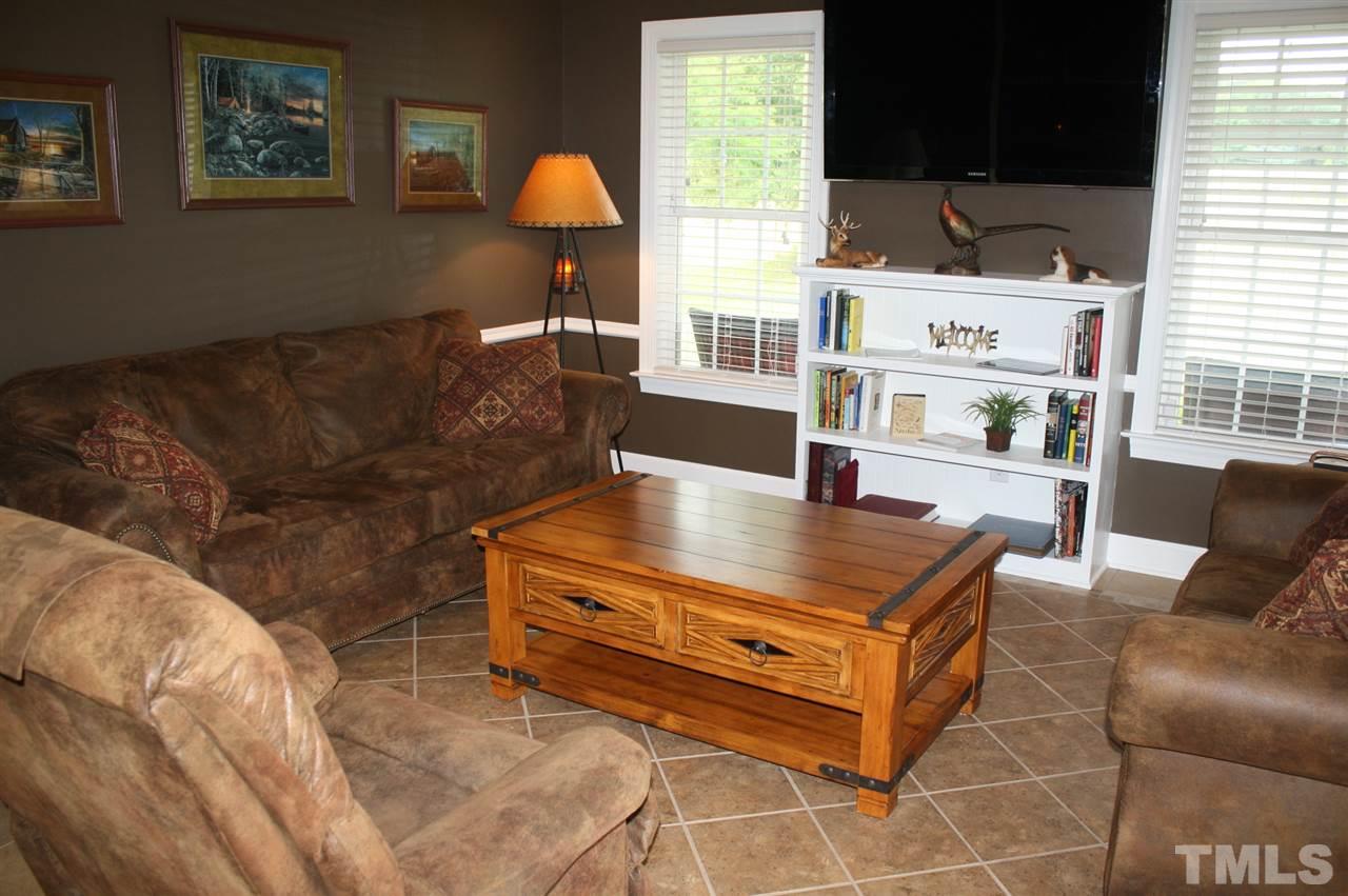 385 Huford Harris Road Spring Hope, NC 27882 - Photo 4 of 25 This lovely family room boasts beautiful tile flooring, chair railing, and a built-in bookcase.