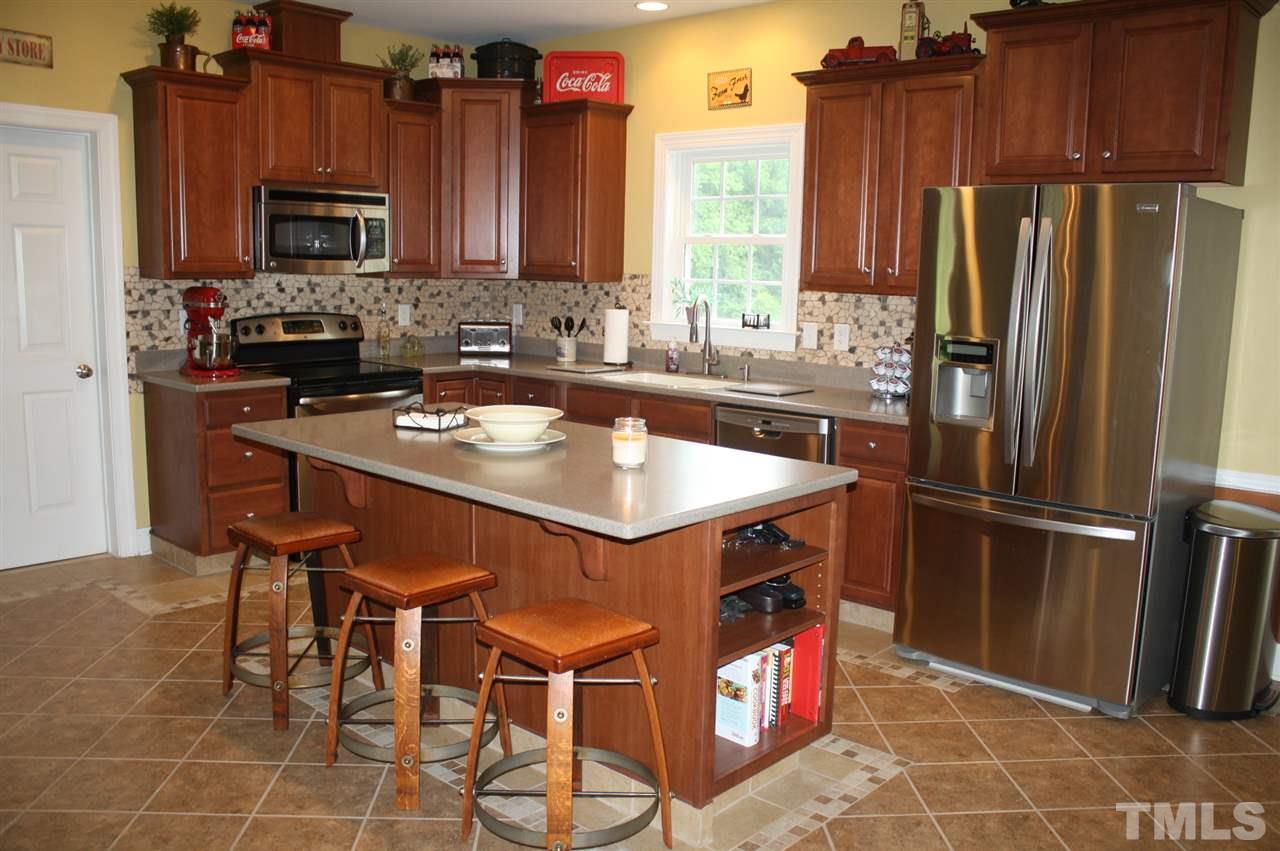 385 Huford Harris Road Spring Hope, NC 27882 - Photo 6 of 25 This gourmet kitchen is sure to please the chef in your home! The stainless steel appliance package includes an electric range with a self-cleaning oven, a built-in microwave, dishwasher and refrigerator. The breakfast bar provides additional seating.