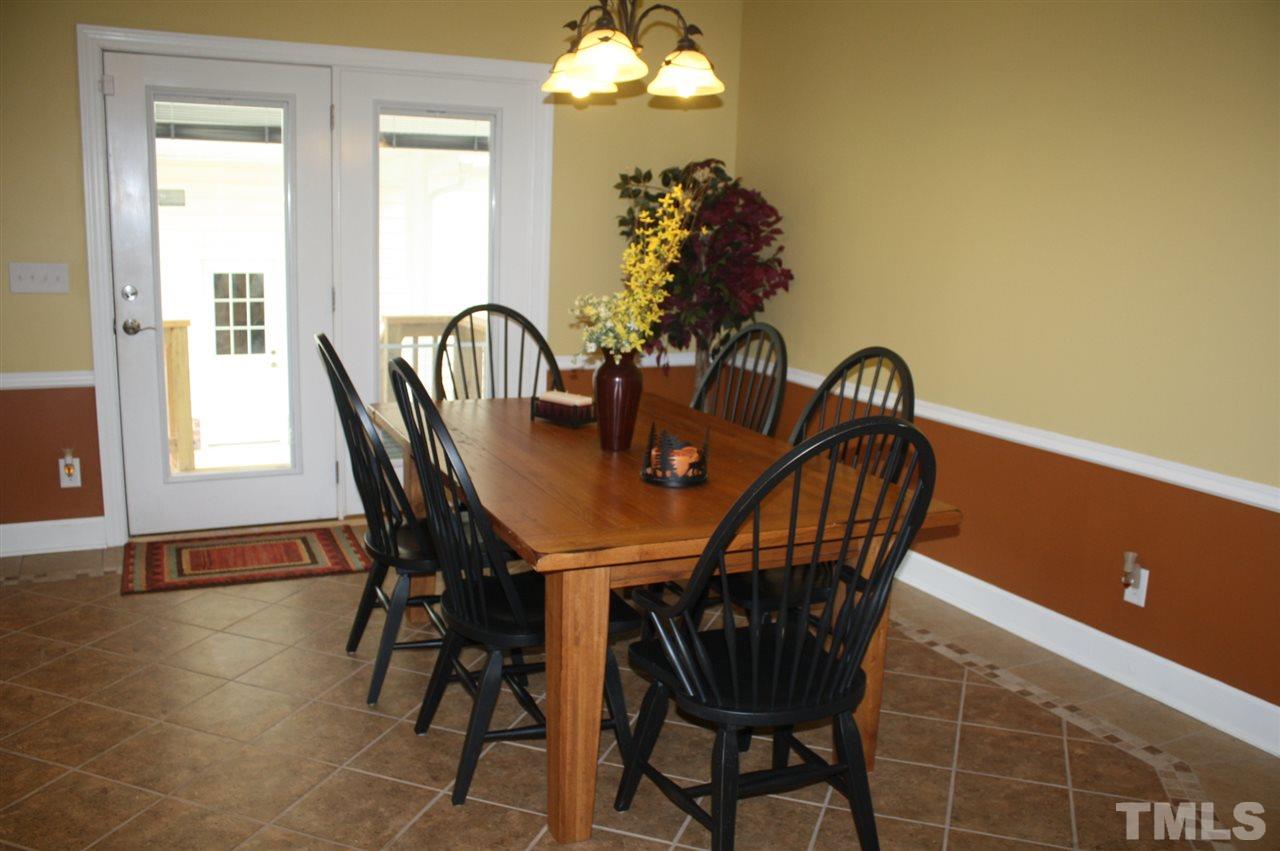 385 Huford Harris Road Spring Hope, NC 27882 - Photo 9 of 25 This lovely dining area boasts beautiful tile flooring, chair railing, and a lovely chandelier. French doors lead to the patio and breezeway.