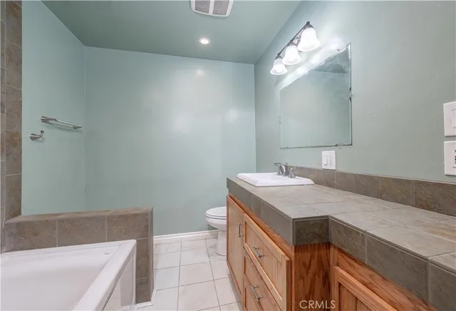 a bathroom with a sink a vanity and a mirror