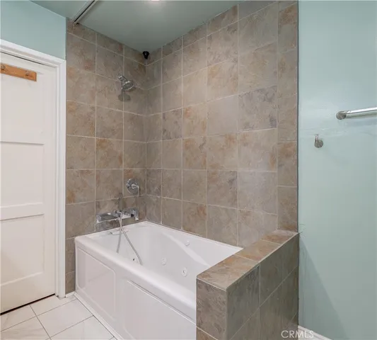 a bath tub sitting next to a white sink
