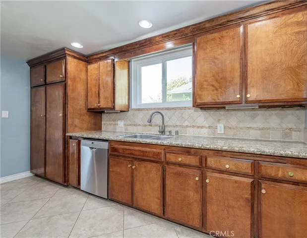 a kitchen with stainless steel appliances granite countertop a sink and cabinets