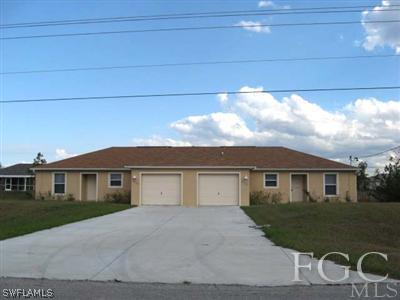 2312 Park Road Lehigh Acres, FL 33971 - Photo 1 of 10 a front view of a house with garage