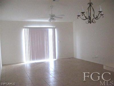 2312 Park Road Lehigh Acres, FL 33971 - Photo 3 of 10 an empty room with wooden floor and windows