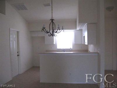 2312 Park Road Lehigh Acres, FL 33971 - Photo 10 of 10 a bathroom with a granite countertop sink a window and a mirror