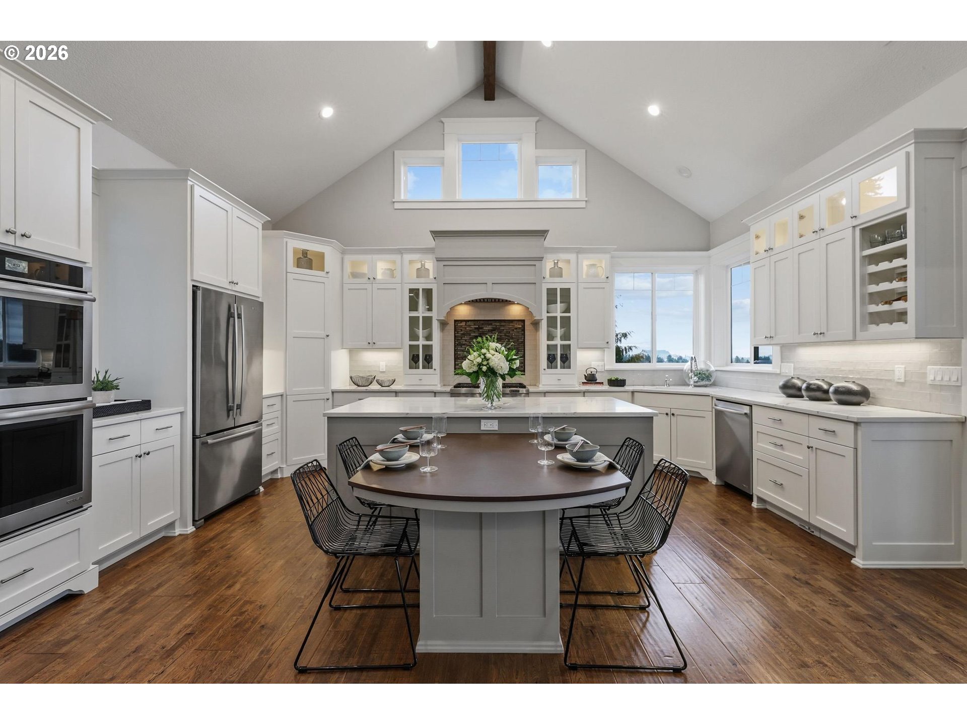 23875 Southwest Newland Road Wilsonville, OR 97070 - Photo 5 of 40 a kitchen with kitchen island a counter top space a sink cabinets and stainless steel appliances