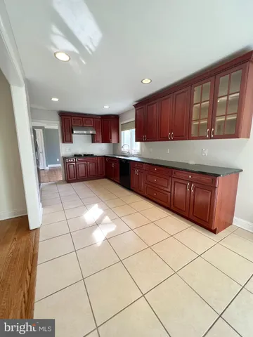 a kitchen with stainless steel appliances a sink a stove a microwave a counter top space and cabinets