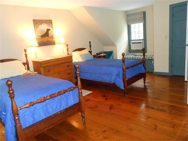 119 Service Road Sandwich, MA 02537 - Photo 19 of 29 a bedroom with a bed and wooden floor