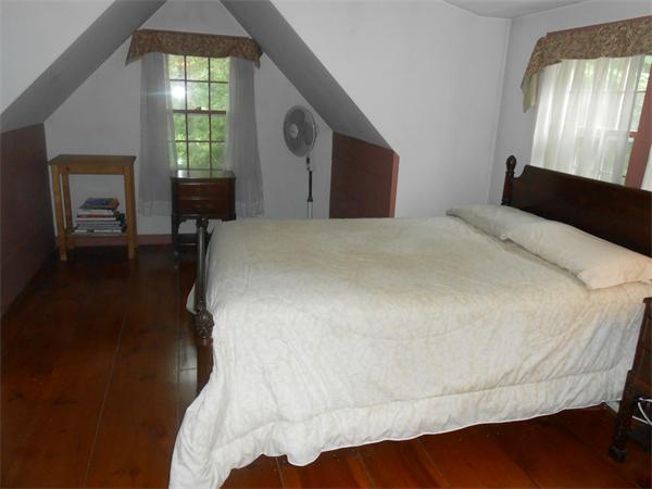 119 Service Road Sandwich, MA 02537 - Photo 20 of 29 a bed sitting in a bedroom next to a window